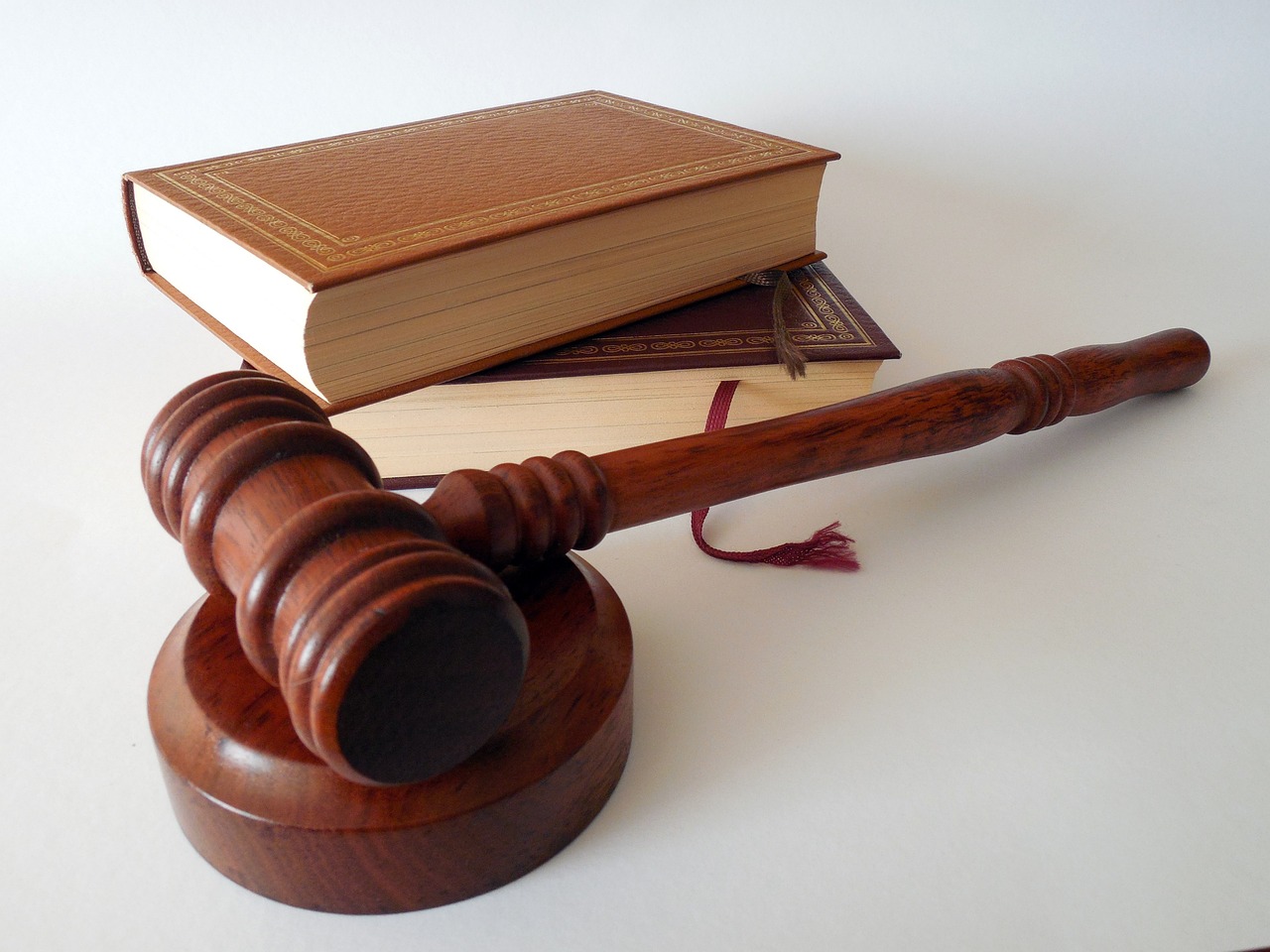 Judge's hammer next to books